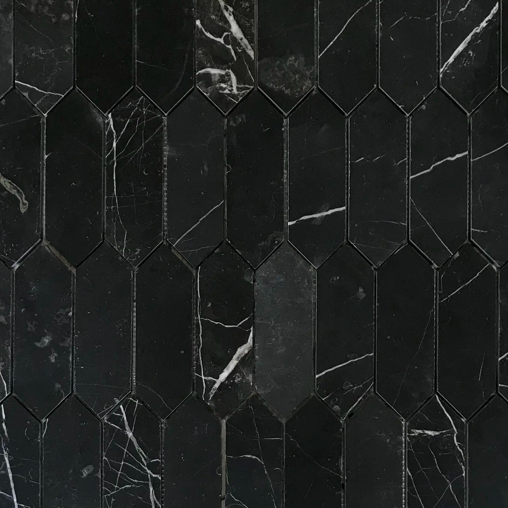 Close detail of white calcite veining across the honed Nero Marquina marble pickets
