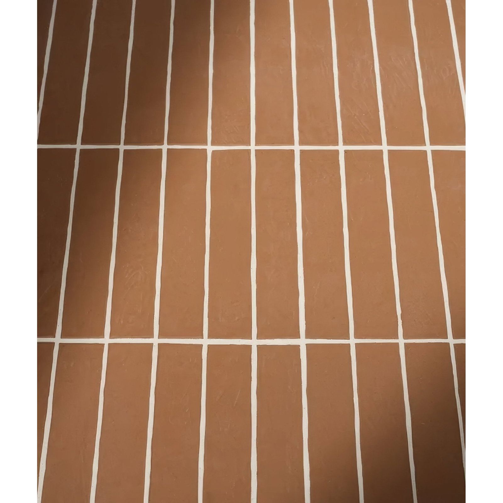 Brown rectangular earthenware porcelain coral tiles with white grout lines for flooring and wall applications