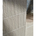 Gray earthenware porcelain linen faux stone wall panel with textured vertical rectangular tiles in a grid pattern