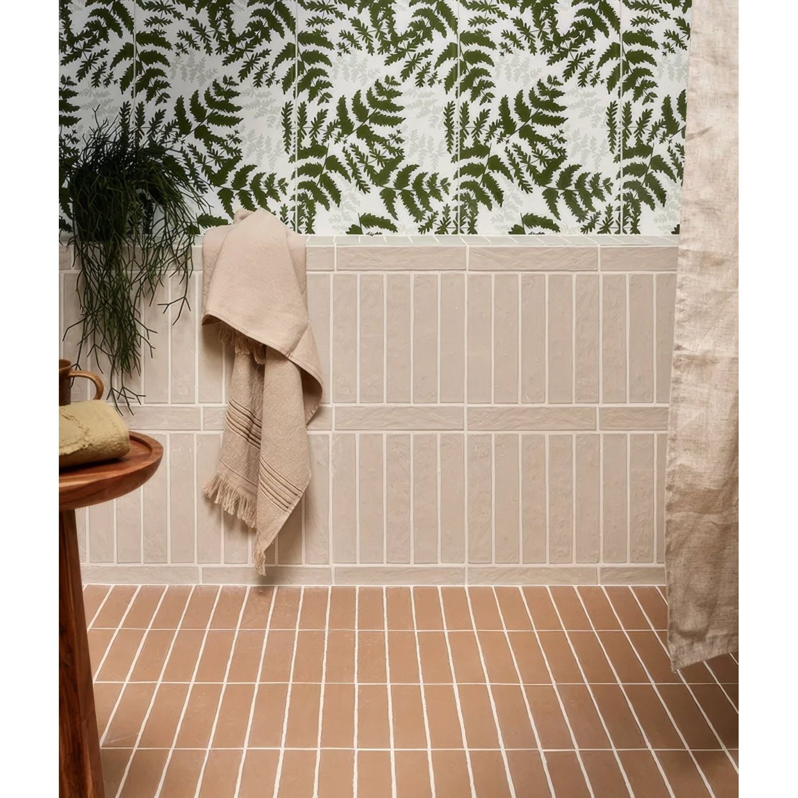 Beige earthenware porcelain plaster towel with frayed edges and subtle horizontal stripes hanging on tiled wall