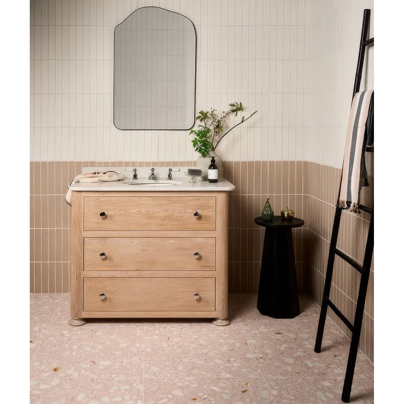 Light wood three-drawer bathroom vanity with round metal knobs and white earthenware porcelain soft white countertop