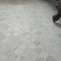 White marble mosaic tiles in an east hampton arabesque pattern with quatrefoil design and subtle gray veining