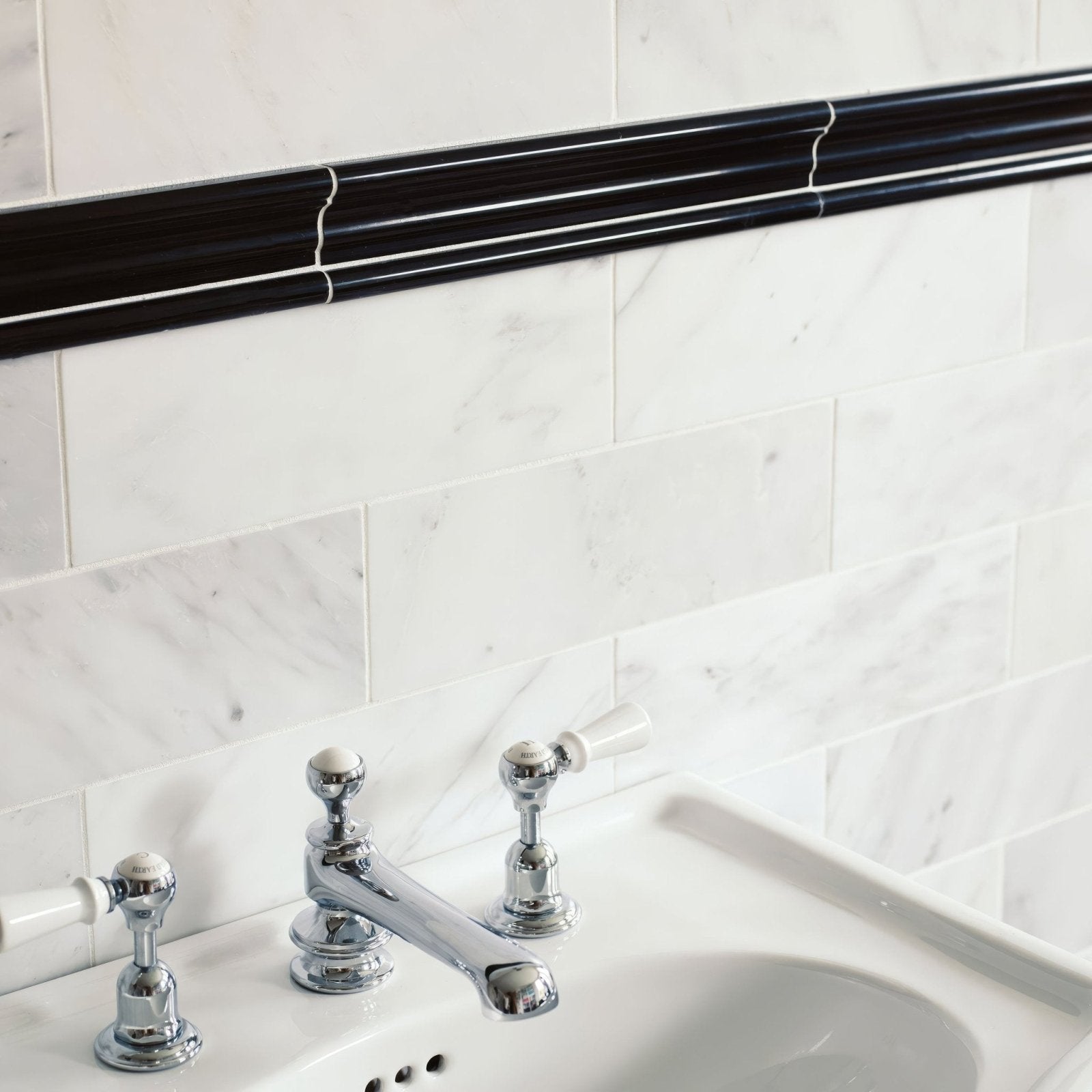 East Hampton Black Marble Dado black and white marble dado tiles with a sink and chrome tap