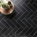 East hampton black marble tile 10x30cm with white veining arranged in a herringbone pattern