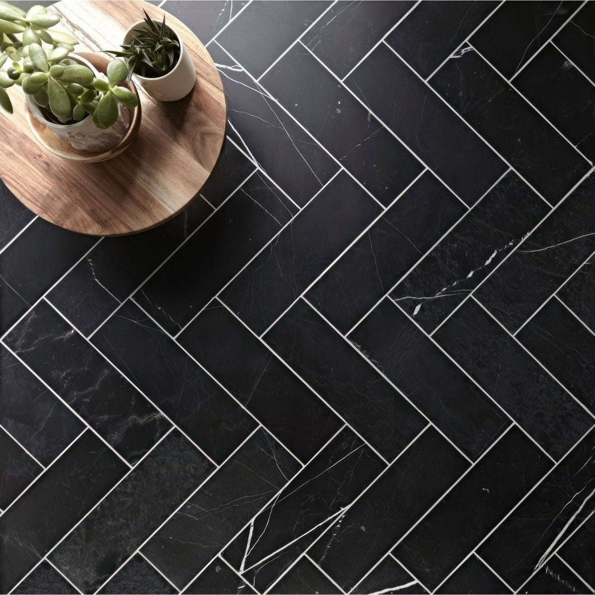 East hampton black marble tile 10x30cm with white veining arranged in a herringbone pattern
