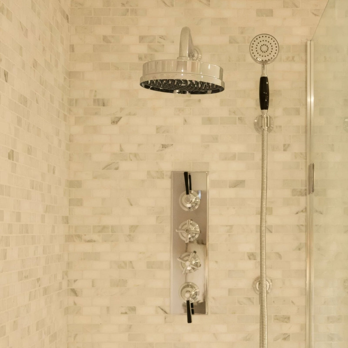 East Hampton Brick Marble Mosaic white marble brick mosaic in a bathroom with a chrome shower system