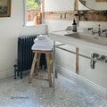 East Hampton Large Hexagon Marble Mosaic white marble hexagon mosaic behind a white sink and black radiator