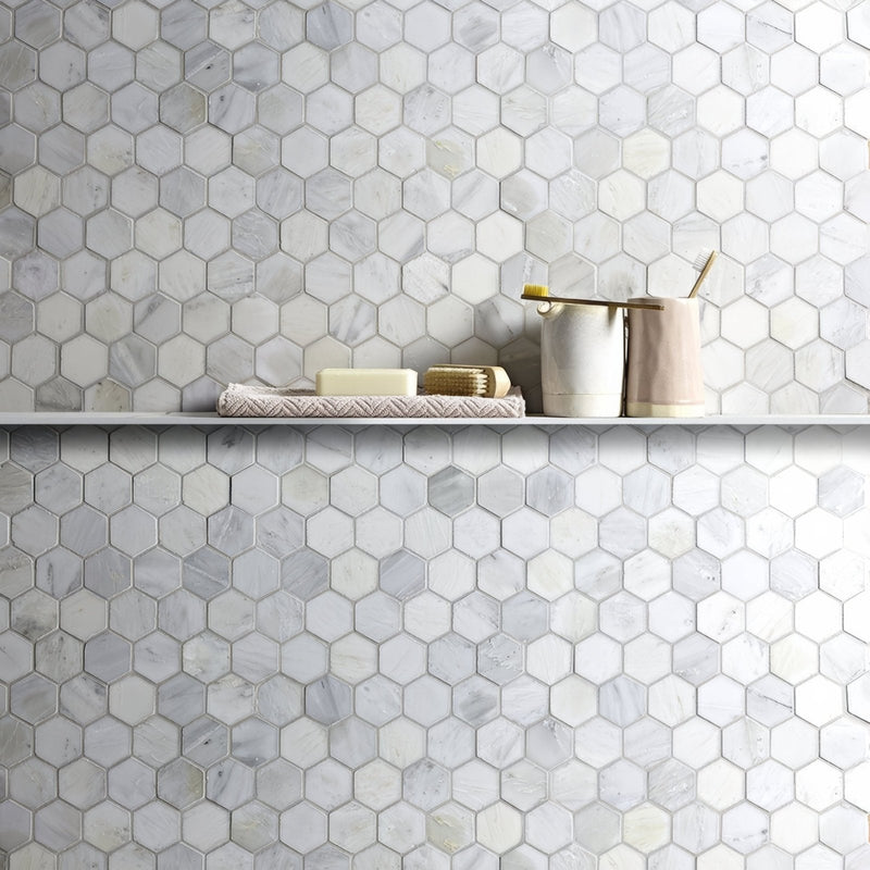 East Hampton Large Hexagon Marble Mosaic tiles on a wall with a shelf below