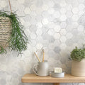 East Hampton Large Hexagon Marble Mosaic white marble hexagon mosaic with a grey mug holding wooden toothbrushes