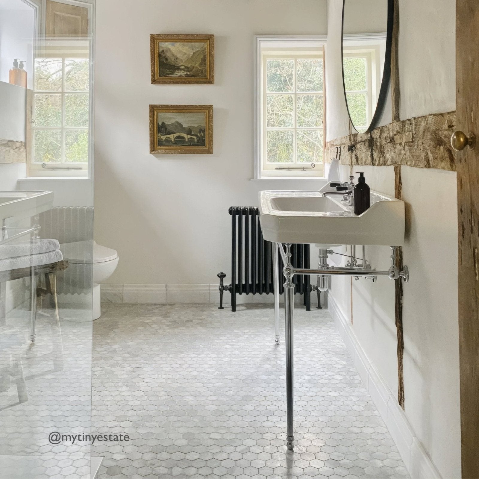 East Hampton Large Hexagon Marble Mosaic white marble hexagon mosaic above a white pedestal sink and black radiator