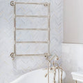 East Hampton Marble Chevron Mosaic white marble and gold chevron mosaic with a chrome heated towel rail