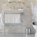 East Hampton Marble Dado white marble dado trim with a white towel over a sink's chrome legs