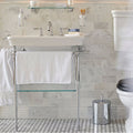 East Hampton Marble Skirting white marble skirting with an embroidered towel