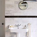 East Hampton Marble Tile 10x30cm white marble tiles with a pedestal sink and chrome tap