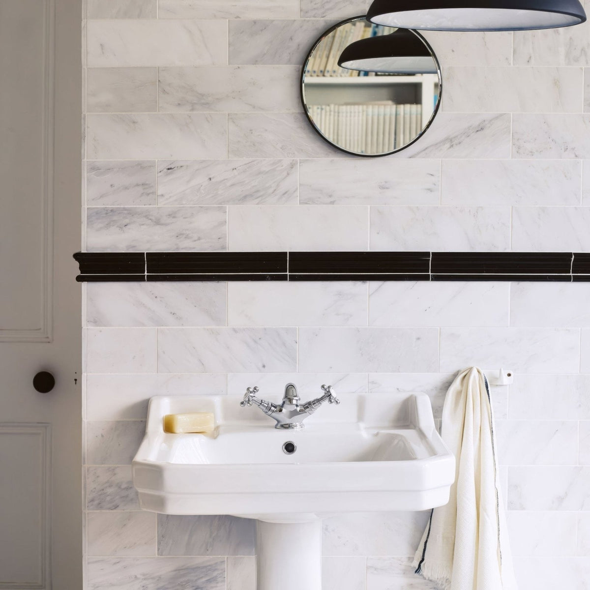East Hampton Marble Tile 10x30cm white marble tiles with a pedestal sink and chrome tap