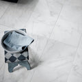 East Hampton Marble Tile 30x30cm white marble tiles with a bowl and denim on a patterned stool