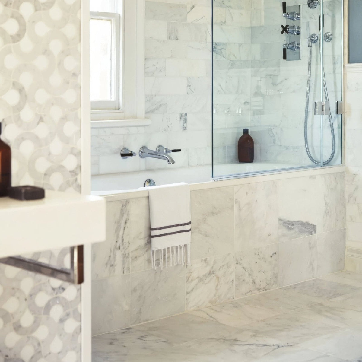East Hampton Marble Tile 30x60cm white marble tiles with a bathtub and glass shower enclosure