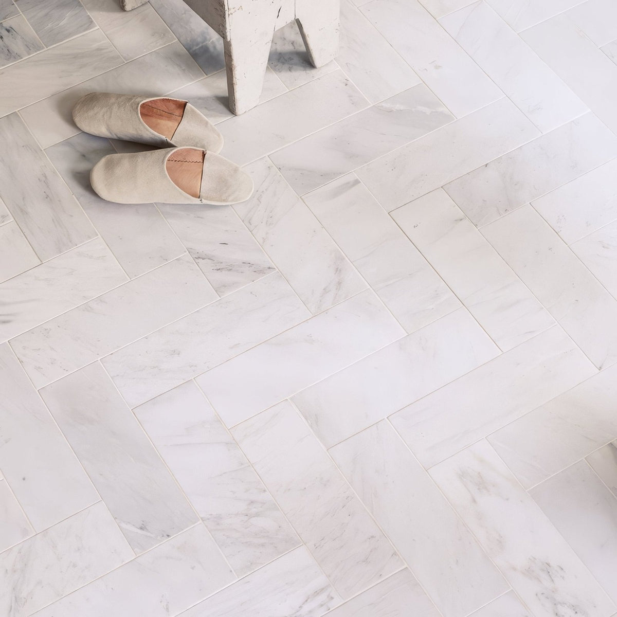 East hampton marble tile 5x20cm featuring beige suede slip-on slippers with soft minimalist design and light brown lining