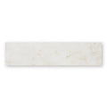 A sleek rectangular white marble tile with beige and gray veining east hampton marble tile 5x20cm