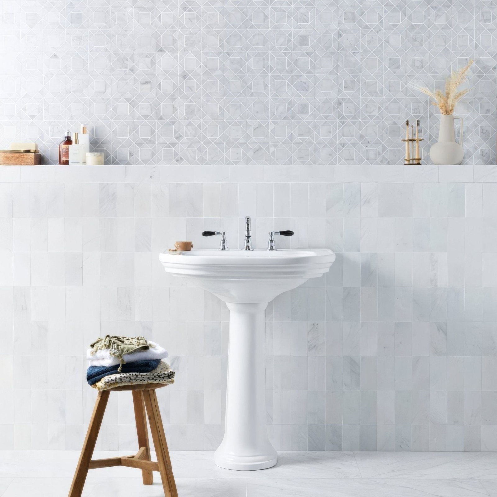 East Hampton Marble Tile 7.5x15cm white marble tiles with a pedestal sink and black handles