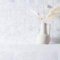 East Hampton Nova Star Marble Mosaic white marble star-pattern mosaic with a white ceramic pitcher of pampas grass