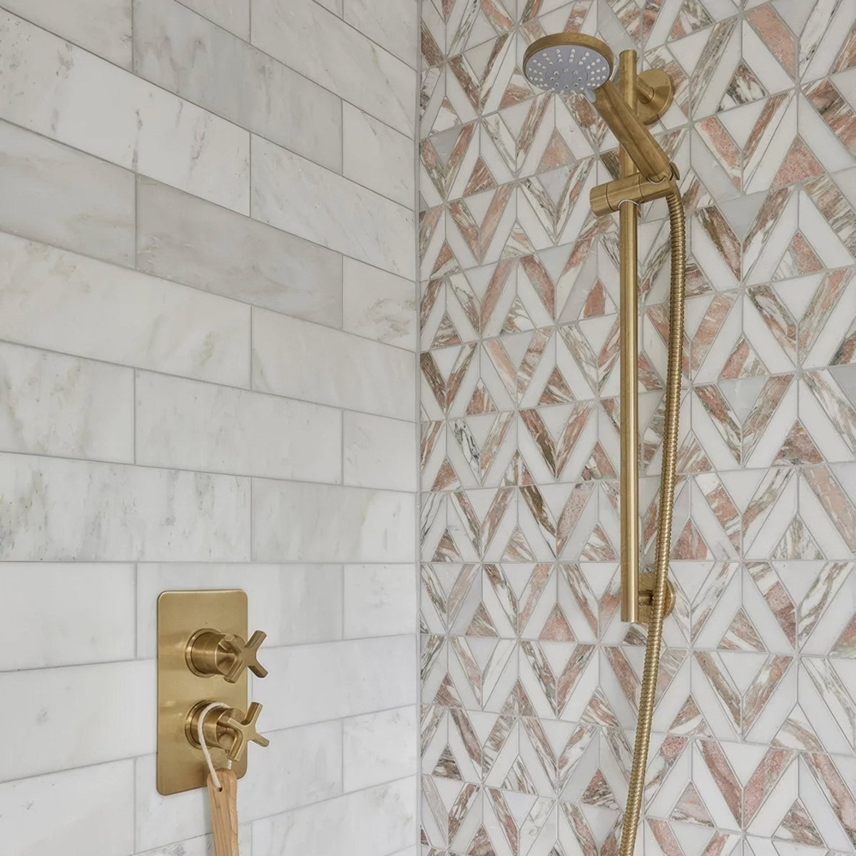 East Java Flamingo Marble Temple Mosaic pink and white marble triangle mosaic with a gold shower fixture