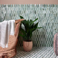 East Java Hummingbird Marble Plume Mosaic light green marble fish-scale mosaic with a pink ceramic planter and green plant