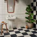 East Village Porcelain Nero 60 x 60cm black marble-effect porcelain tile with a white pedestal sink