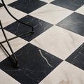 Black and white marble effect porcelain floor tiles arranged in a classic checkered pattern east village nero 60 x 60cm