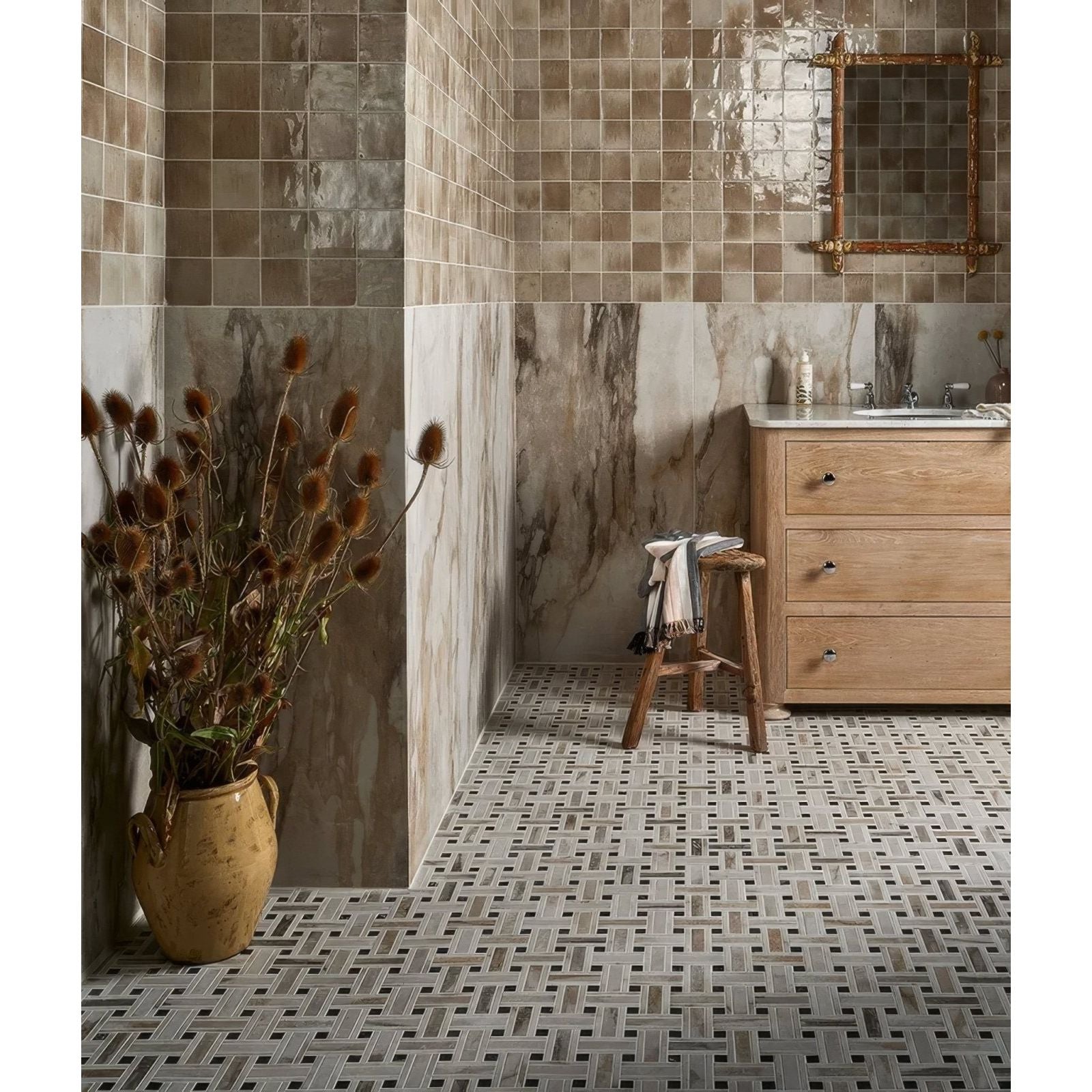 East Village Porcelain Oro 60 x 120cm beige and grey marble-effect porcelain tile with a terracotta vase of dried thistles