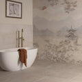 White freestanding bathtub with a brown towel draped over the edge in Eastern Mist decorative 8-tile set panel c