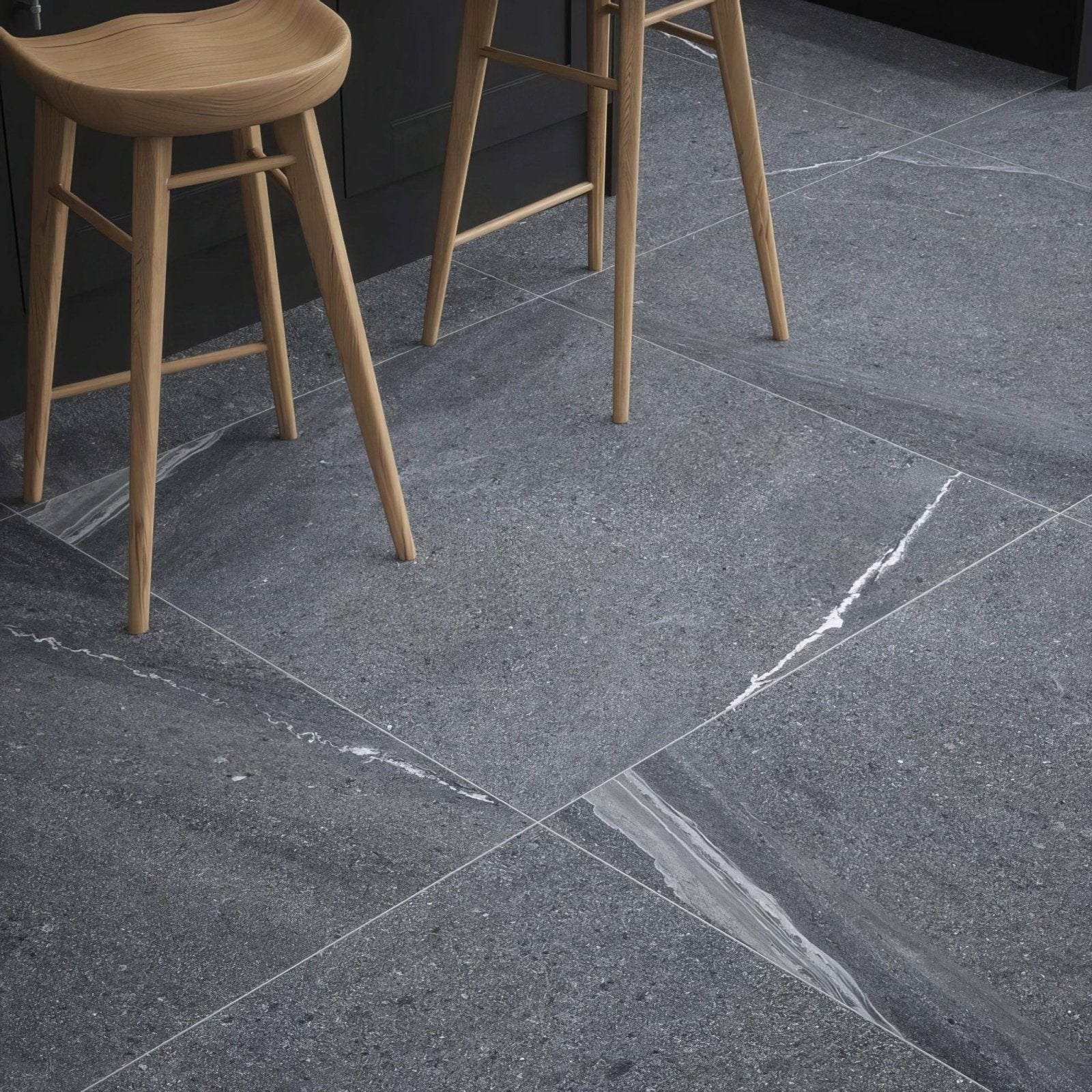 Dark gray eastford anthracite matt porcelain stone tiles with subtle white veining in a modern kitchen setting