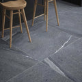 Dark gray eastford anthracite matt porcelain stone tiles with subtle white veining in a modern kitchen setting