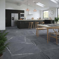 Dark gray stone eastford anthracite matt porcelain tiles with white veining covering the kitchen floor