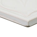 White ceramic tile edwardian acanthus highgate with subtle marbled veining and a glossy finish