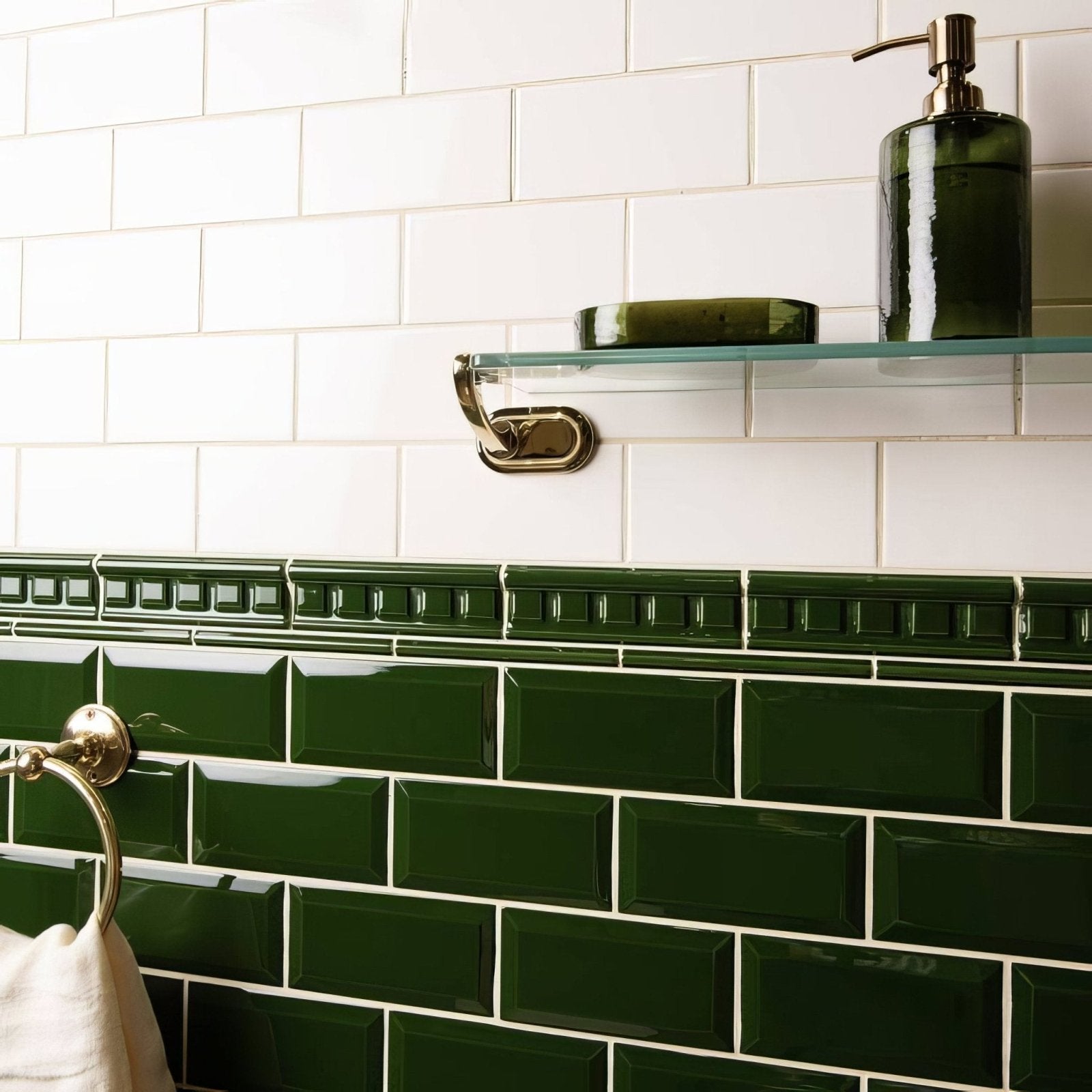 Edwardian green dentil moulding featuring deep green glossy rectangular subway tiles with decorative border and white grout