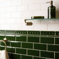Edwardian green metro bevelled tile featuring dark green glossy rectangular subway tiles with decorative border section