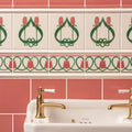 White ceramic sink with gold toned faucets and white porcelain handles set against elysée border vintage white tulip tiles