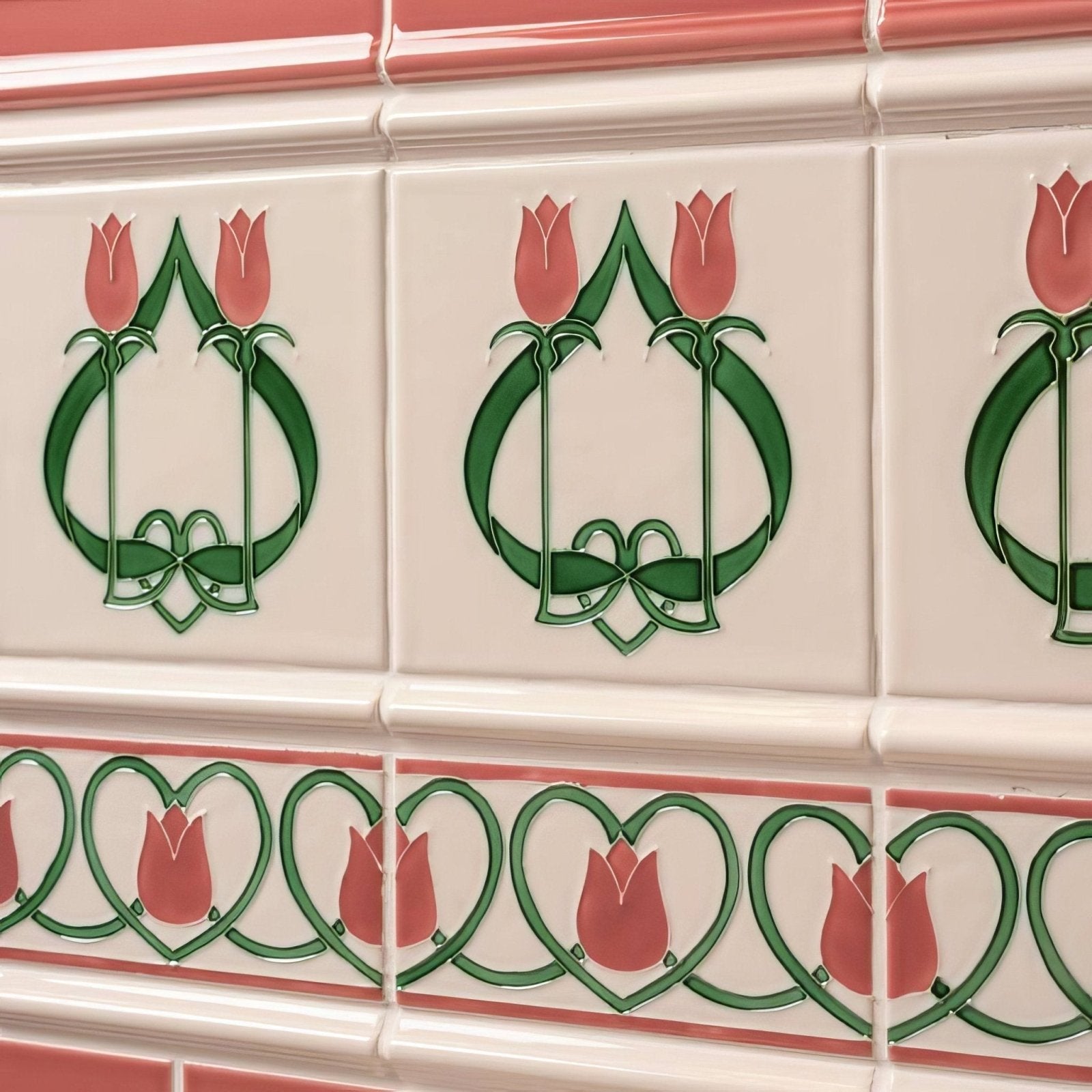 White ceramic tiles with pink and green art nouveau tulip motifs in a repeating pattern from elysée border vintage white