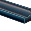 A sleek glossy teal ceramic empress dado tourmaline tile with subtle gradient finish and smooth rounded edges