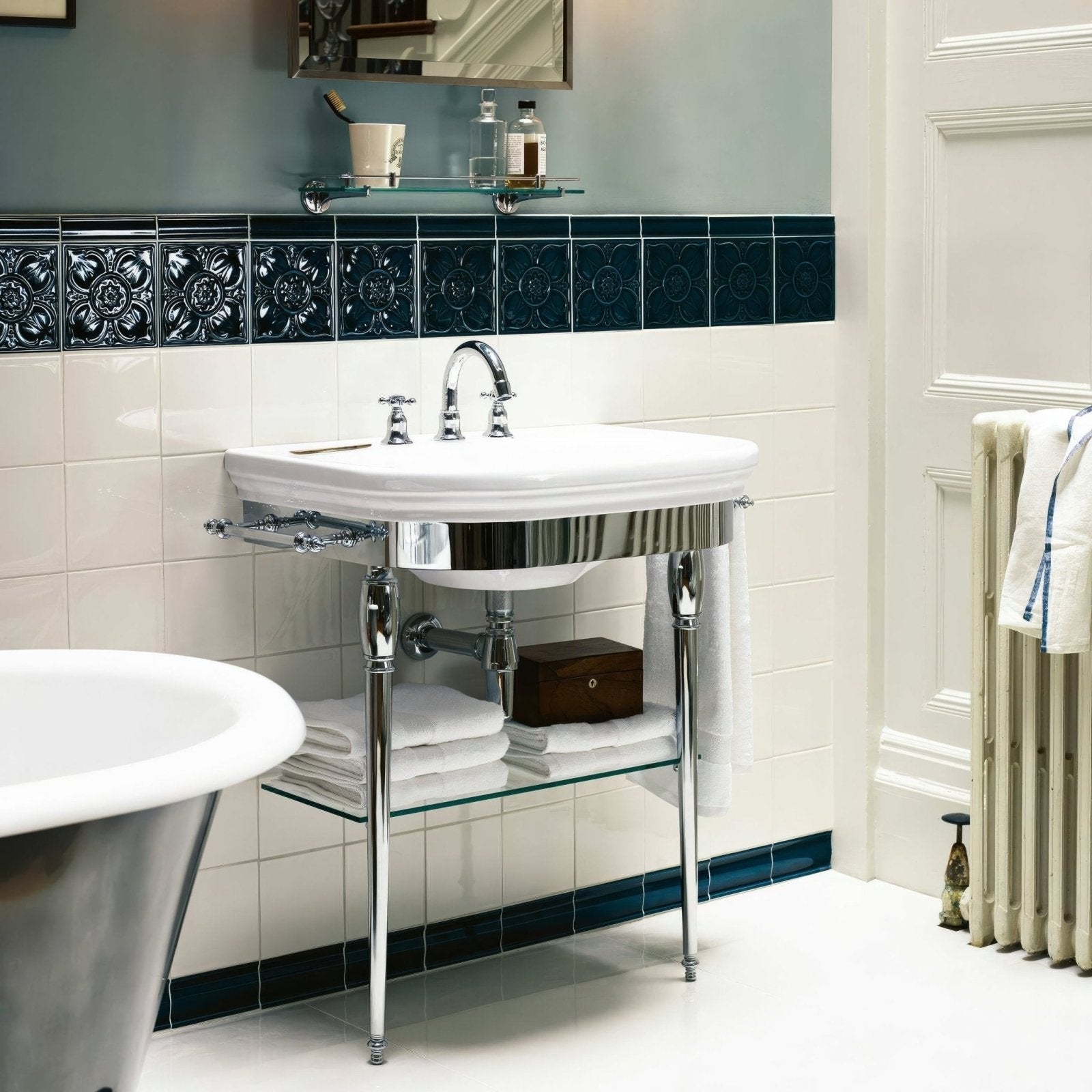 White ceramic Empress Pearl Base pedestal sink with polished chrome legs and matching faucet for bathroom use