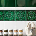 Deep emerald green ceramic tiles with raised floral patterns for wall decoration in empress pearl base collection