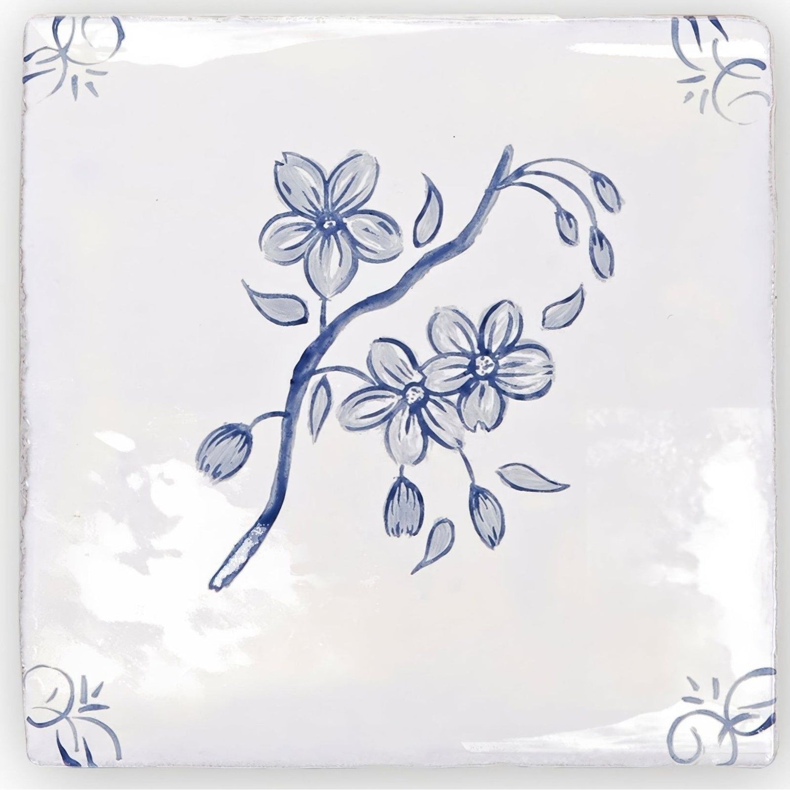 White ceramic English Delft Blossom Blue gloss tile with delicate blue floral blossoms and buds on a branch design