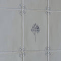 White ceramic tile english delft charcoal bee with gray floral and insect illustration and decorative corner motifs
