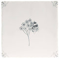 A cream-colored ceramic English Delft charcoal bee tile with a hand-drawn black ink bumblebee and floral design