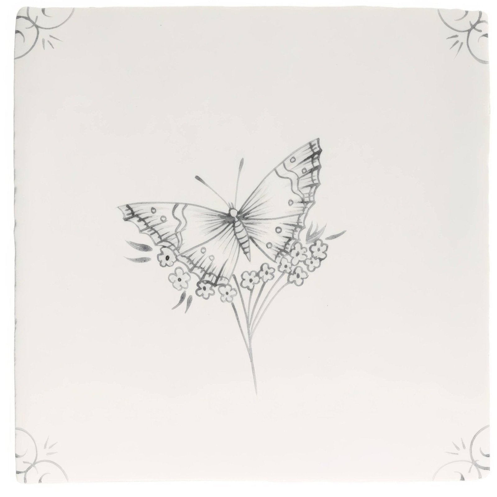 A delicate black and white butterfly illustration on an off white ceramic tile with small flowers in English Delft Charcoal Butterfly 1