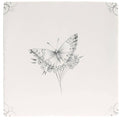 A delicate black and white butterfly illustration on an off white ceramic tile with small flowers in English Delft Charcoal Butterfly 1