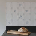 A rustic artisanal sourdough bread loaf with golden crust and flour dusting on a wooden board for english delft charcoal dragonfly