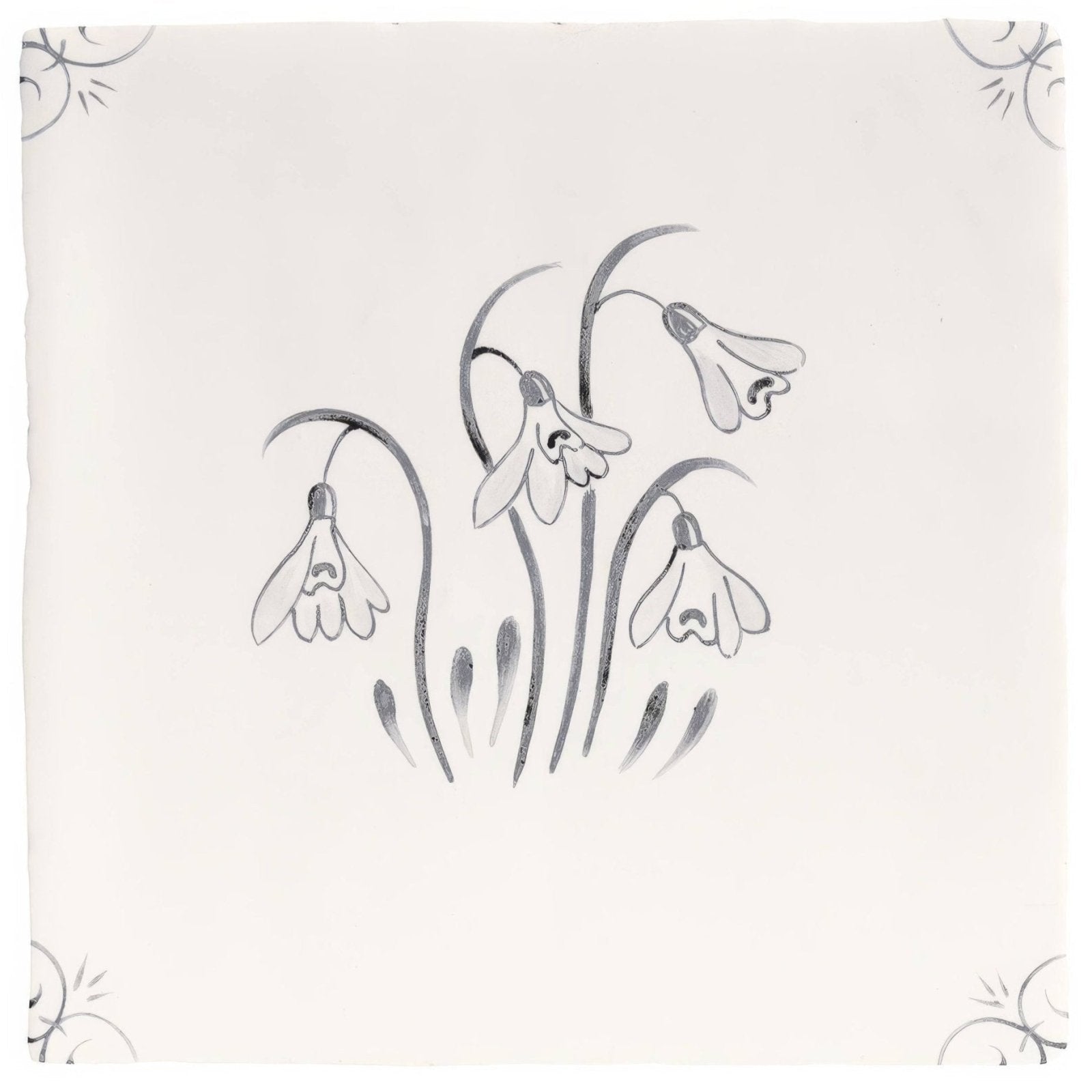 A square off-white ceramic tile with a delicate gray hand-painted snowdrop design from english delft charcoal snowdrop collection
