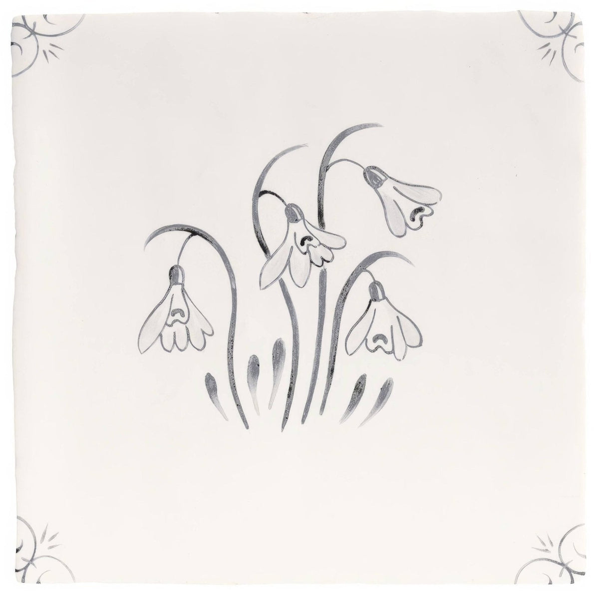 A square off-white ceramic tile with a delicate gray hand-painted snowdrop design from english delft charcoal snowdrop collection